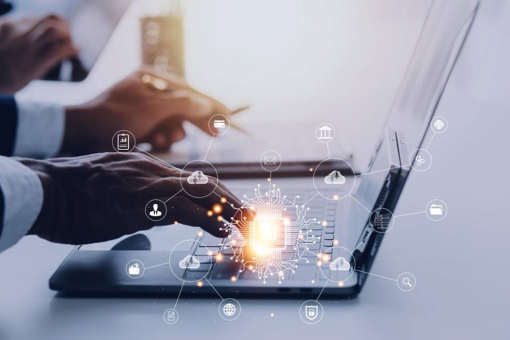 Hands on a laptop with network and cloud icons representing enterprise IT solutions